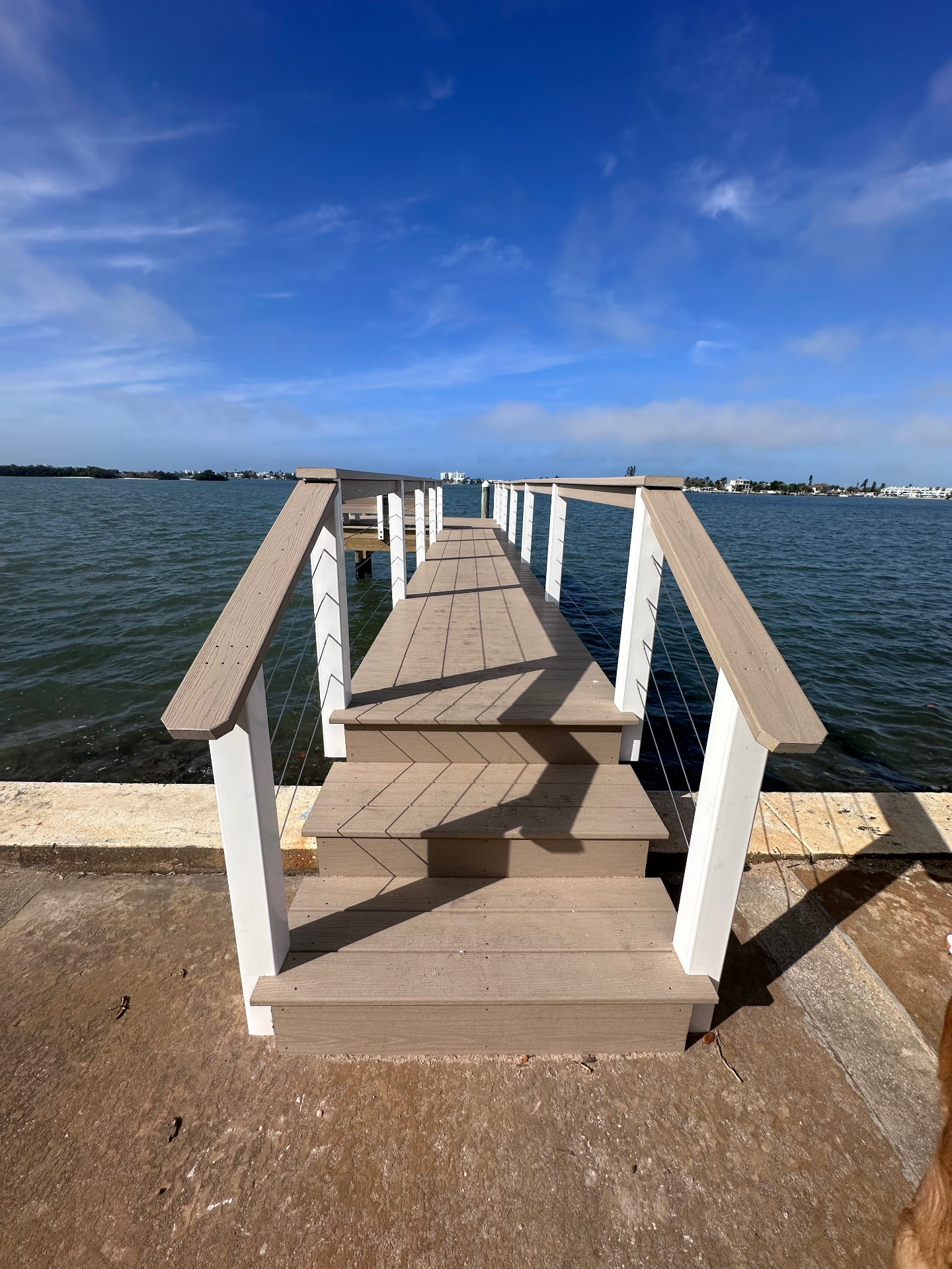Composite dock walkway with cable railings over the bay